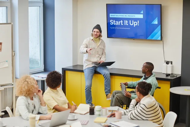 A diverse group in an office meeting discussing startup strategies and innovative ideas. Preparing a clear internal product launch brief
