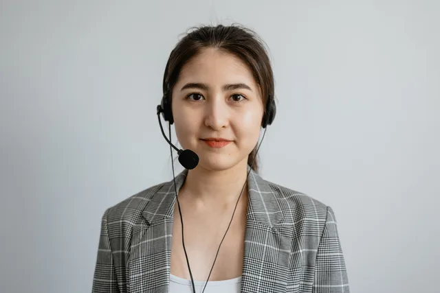 Portrait of a young female call center agent in a professional setting wearing a headset. Separating useful guidance from a rigid script